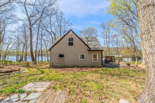 view of property exterior featuring a shingled roof