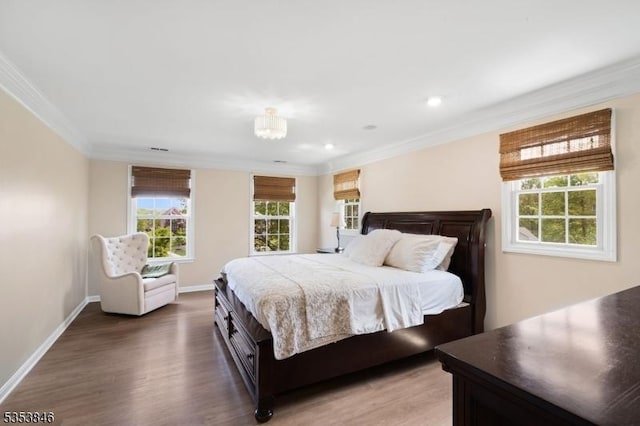 bedroom with ornamental molding, light wood-style flooring, and multiple windows