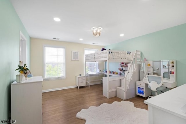 bedroom featuring visible vents, wood finished floors, baseboards, and recessed lighting