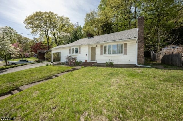 ranch-style home featuring a chimney, a garage, fence, a front lawn, and concrete driveway