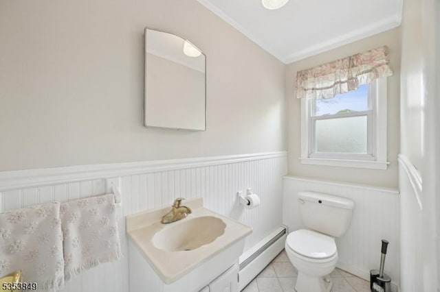 bathroom featuring vanity, tile patterned flooring, wainscoting, toilet, and a baseboard radiator