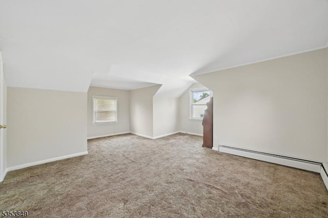 additional living space with carpet floors, a wealth of natural light, and lofted ceiling