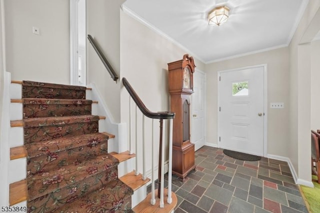 foyer with crown molding, baseboards, stone finish flooring, and stairway