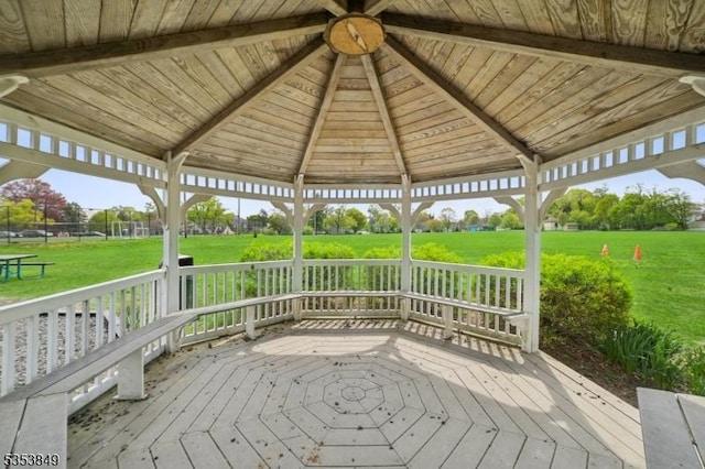 wooden deck with a gazebo and a lawn
