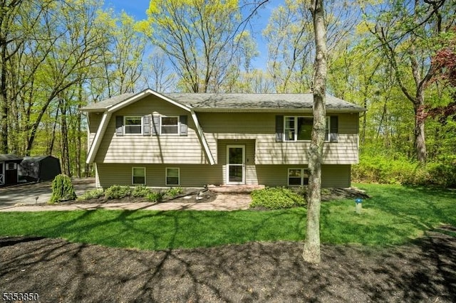 back of property with a lawn