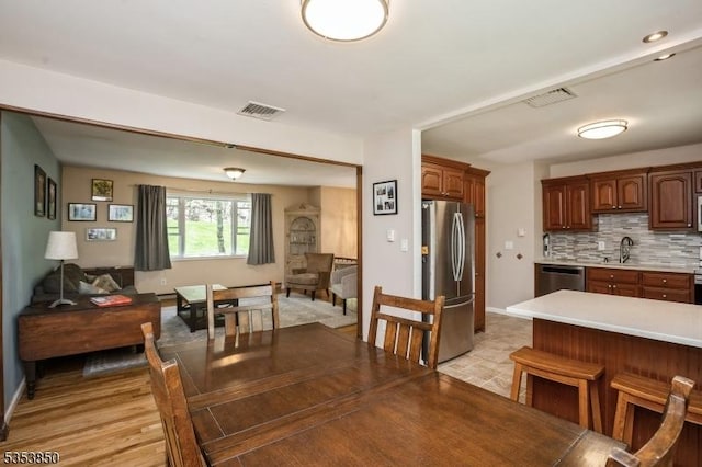 dining room featuring visible vents and baseboards