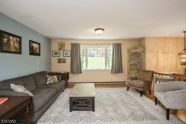 living area with wood finished floors and a notable chandelier