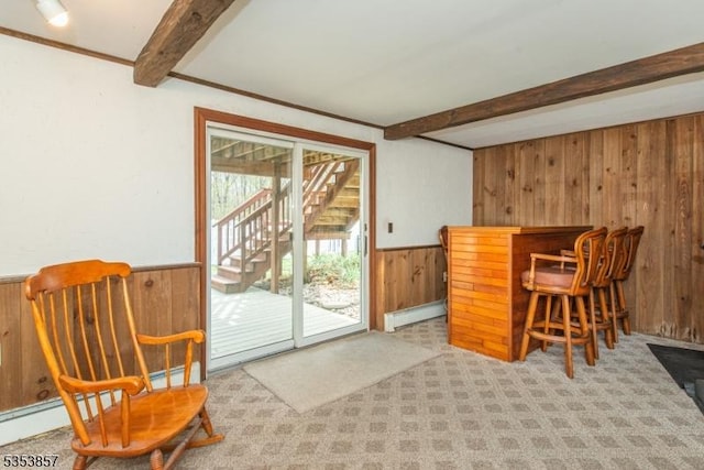 sitting room with a dry bar, wood walls, carpet floors, a wainscoted wall, and beamed ceiling