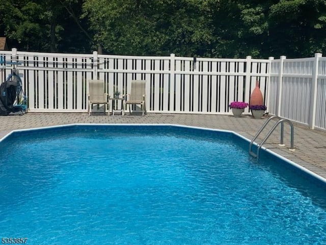 view of swimming pool with fence, a fenced in pool, and a patio