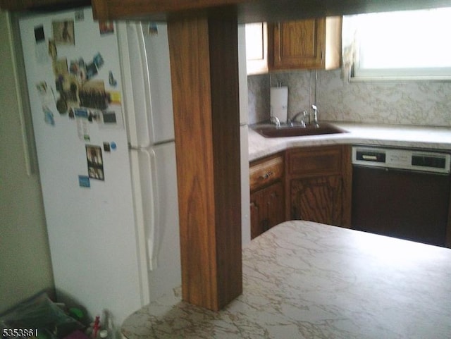 5 Franklin Ave, Montclair Twp, NJ 07042 - kitchen featuring brown cabinetry, a sink, light countertops, freestanding refrigerator, and black dishwasher
