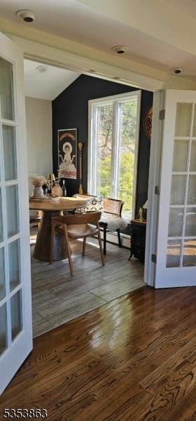 office space featuring dark wood finished floors and vaulted ceiling