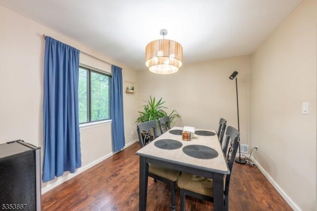 2324 Old Stone Mill Dr, East Windsor Twp, NJ 08512 - dining space featuring wood finished floors, baseboards, and a chandelier