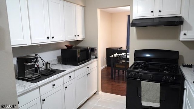 2324 Old Stone Mill Dr, East Windsor Twp, NJ 08512 - kitchen featuring black appliances, under cabinet range hood, white cabinets, and light stone counters