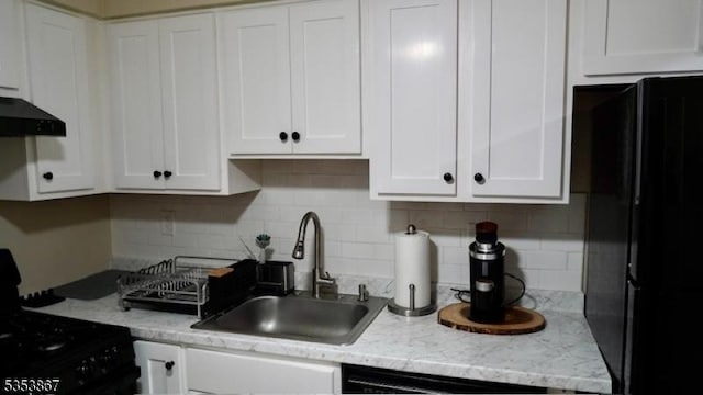 2324 Old Stone Mill Dr, East Windsor Twp, NJ 08512 - kitchen with black appliances, a sink, white cabinetry, and decorative backsplash