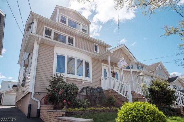 american foursquare style home with a garage