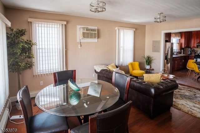 dining space featuring a wall unit AC, baseboard heating, and dark wood-type flooring