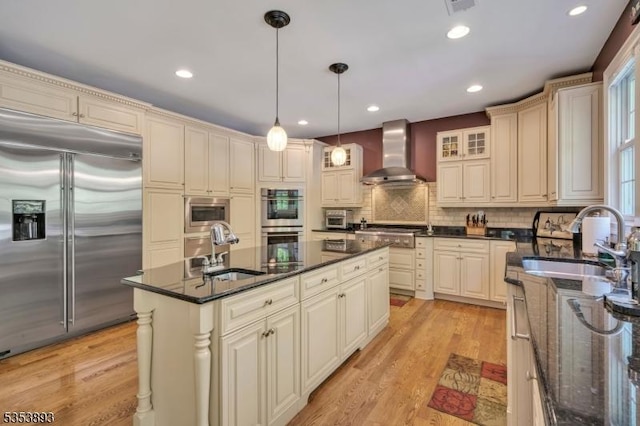 28 Arbor Rd, North Caldwell Boro, NJ 07006 - kitchen featuring built in appliances, wall chimney range hood, a sink, cream cabinets, and recessed lighting
