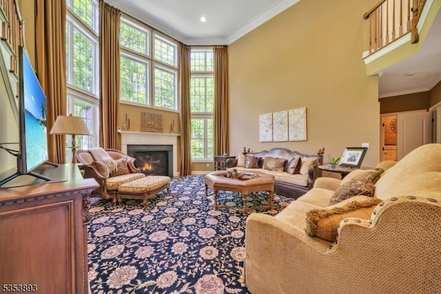 28 Arbor Rd, North Caldwell Boro, NJ 07006 - living area featuring ornamental molding, a glass covered fireplace, and a towering ceiling