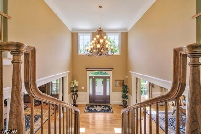 28 Arbor Rd, North Caldwell Boro, NJ 07006 - foyer entrance with healthy amount of natural light, a chandelier, wood finished floors, stairs, and crown molding