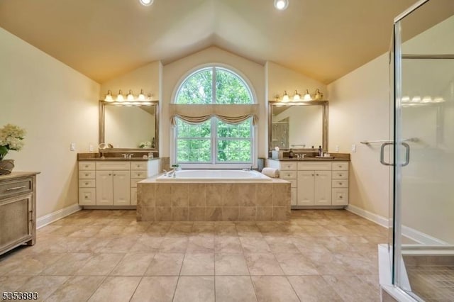 28 Arbor Rd, North Caldwell Boro, NJ 07006 - bathroom with vaulted ceiling, two vanities, a bath, a stall shower, and tile patterned floors