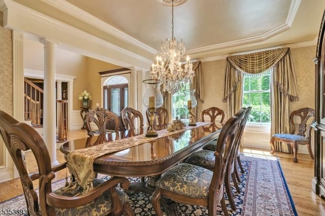 28 Arbor Rd, North Caldwell Boro, NJ 07006 - dining room with a chandelier, a raised ceiling, ornamental molding, light wood-style floors, and wainscoting