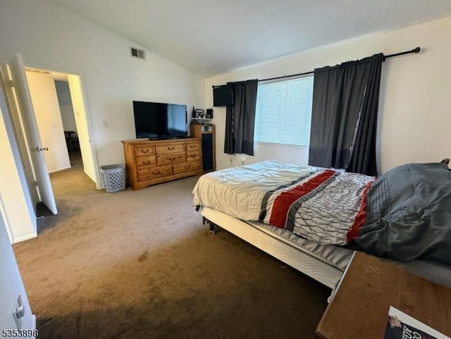 carpeted bedroom with lofted ceiling and visible vents
