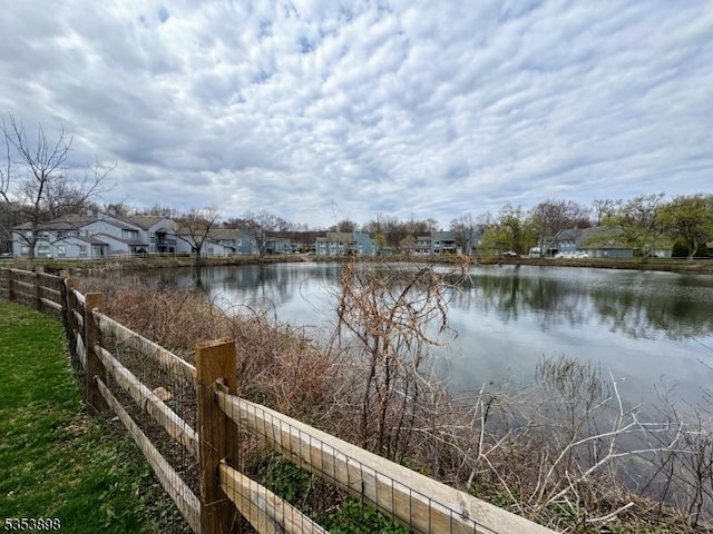 view of water feature with fence and a residential view