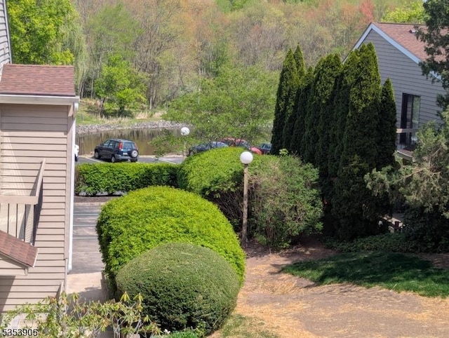 view of yard with a view of trees