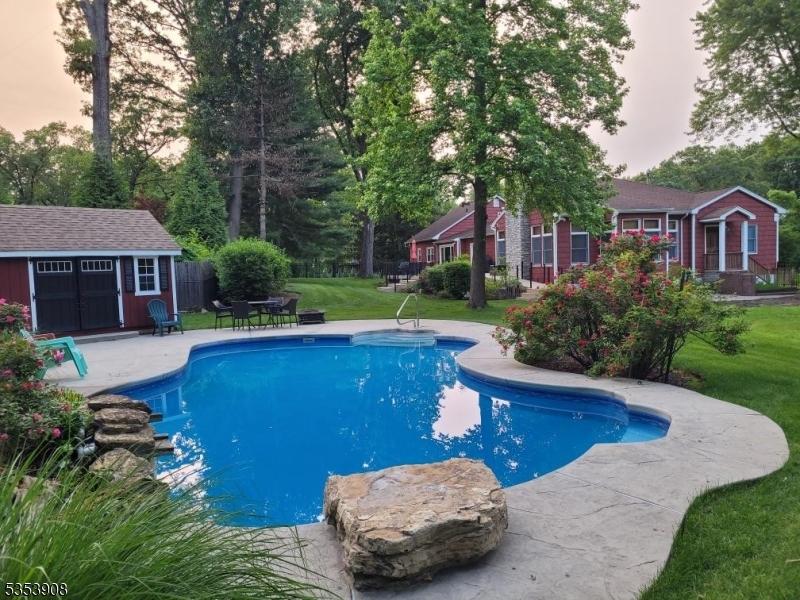6 Heritage Ln, Scotch Plains Twp, NJ 07076 - outdoor pool with a patio and view of wooded area