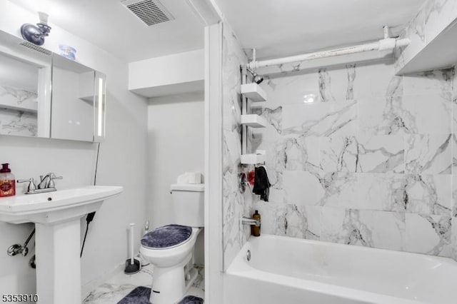 full bathroom featuring visible vents, a sink, toilet, marble finish floor, and bathing tub / shower combination