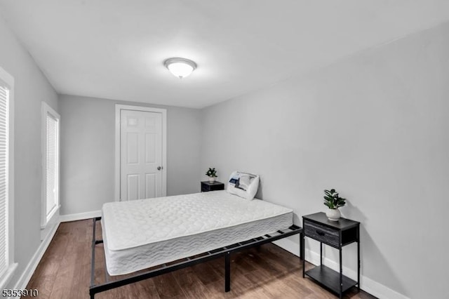 bedroom featuring baseboards and wood finished floors