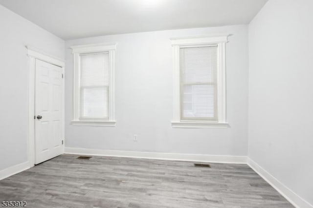 18 Ellis Ave, Irvington Twp, NJ 07111 - unfurnished room featuring baseboards, visible vents, and wood finished floors