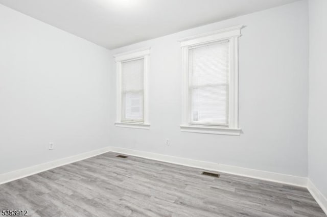 18 Ellis Ave, Irvington Twp, NJ 07111 - unfurnished room featuring visible vents, plenty of natural light, and wood finished floors