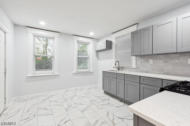 18 Ellis Ave, Irvington Twp, NJ 07111 - kitchen featuring gray cabinetry, light countertops, decorative backsplash, and marble finish floor