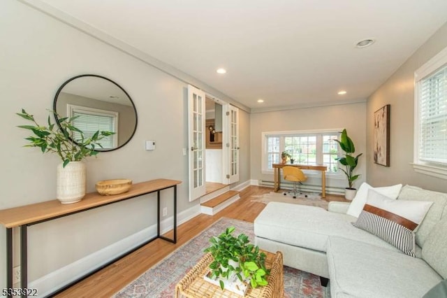 living room with recessed lighting, plenty of natural light, and light wood-type flooring