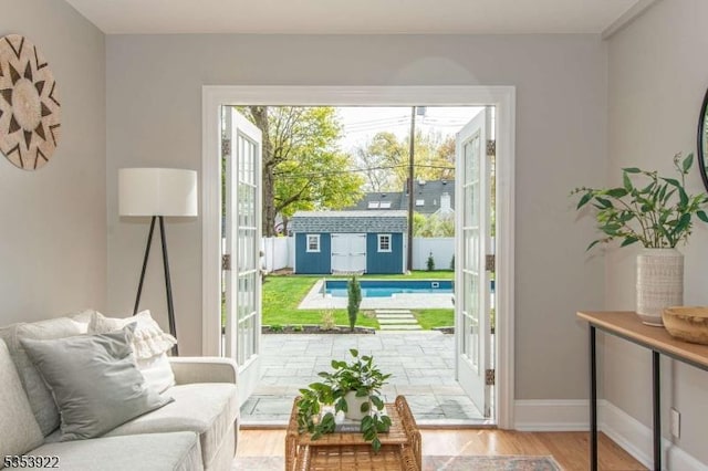 entryway with baseboards and wood finished floors