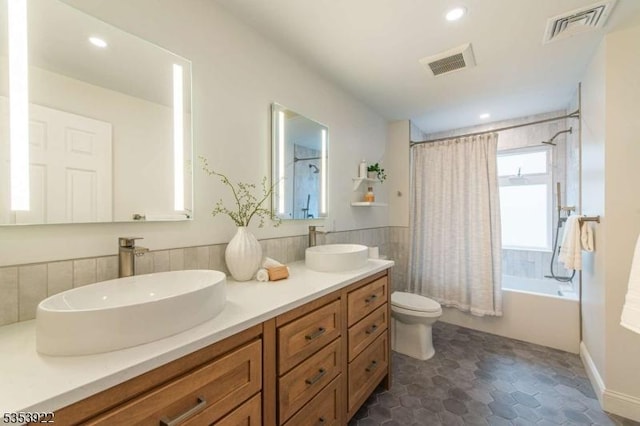 full bath featuring toilet, visible vents, a sink, and shower / tub combo
