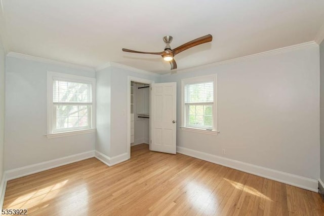 unfurnished bedroom featuring baseboards, ornamental molding, a closet, and light wood-type flooring