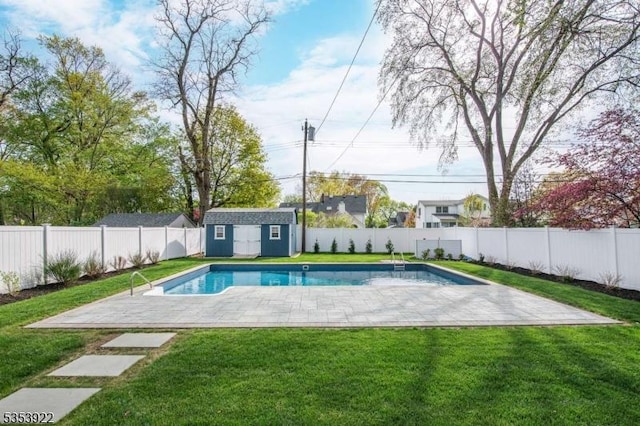 view of pool featuring an outdoor structure, a fenced backyard, a lawn, and a storage shed