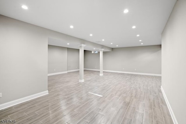 finished basement featuring baseboards, recessed lighting, and wood finished floors