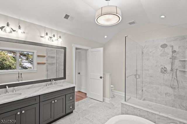 full bath with a sink, a stall shower, double vanity, and lofted ceiling