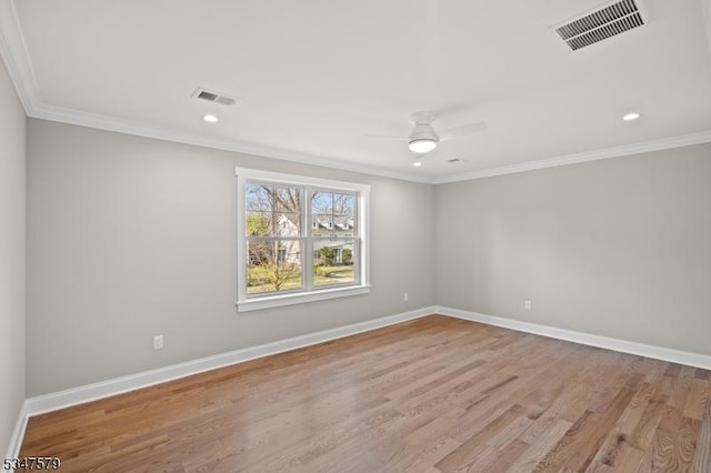 empty room featuring visible vents, a ceiling fan, wood finished floors, and ornamental molding