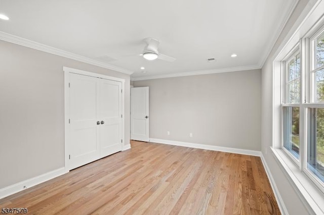 unfurnished bedroom featuring crown molding, baseboards, and light wood-style flooring