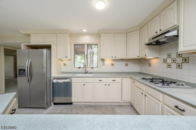 318 Sunnyside Ter, Bridgewater Twp, NJ 08807 - kitchen with crown molding, light countertops, under cabinet range hood, a sink, and appliances with stainless steel finishes
