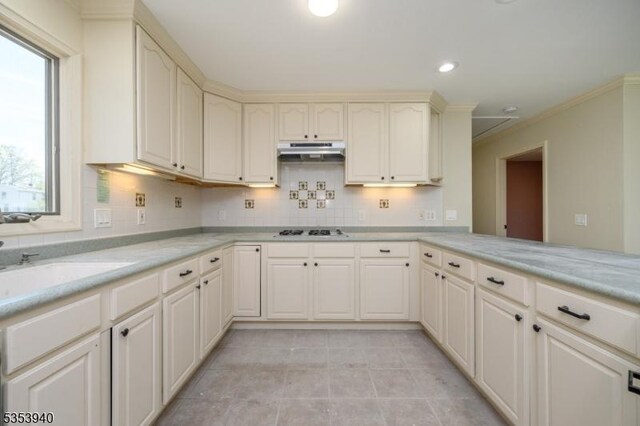 318 Sunnyside Ter, Bridgewater Twp, NJ 08807 - kitchen featuring ornamental molding, white gas cooktop, light countertops, under cabinet range hood, and backsplash