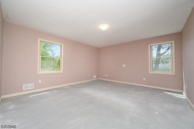 318 Sunnyside Ter, Bridgewater Twp, NJ 08807 - empty room with a healthy amount of sunlight, concrete floors, and visible vents