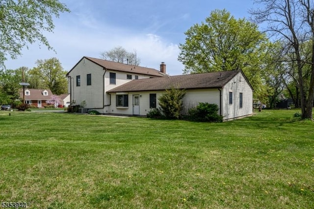 318 Sunnyside Ter, Bridgewater Twp, NJ 08807 - back of house featuring a yard and a chimney