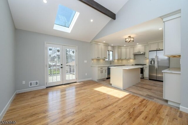 318 Sunnyside Ter, Bridgewater Twp, NJ 08807 - kitchen featuring visible vents, beamed ceiling, light countertops, appliances with stainless steel finishes, and a skylight