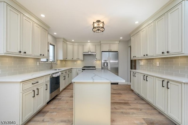 318 Sunnyside Ter, Bridgewater Twp, NJ 08807 - kitchen featuring a sink, backsplash, a kitchen island, and stainless steel appliances
