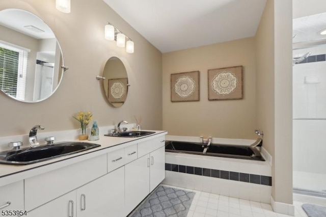 bathroom featuring a shower, double vanity, tile patterned flooring, and tiled tub